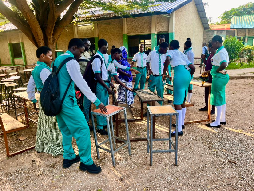 St. Peter's students in school uniform participating in an outdoor workshop
